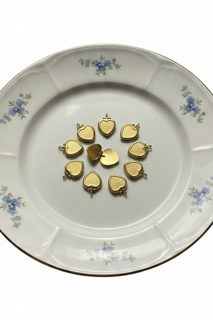 Heart lockets unchanged on floral plate isolated
